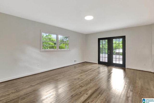 1324 Laurence St, Irondale, AL 35210 - unfurnished room featuring french doors, plenty of natural light, wood finished floors, and baseboards