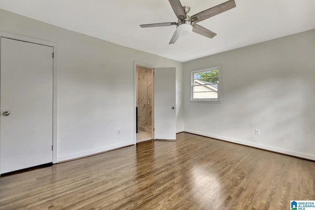1324 Laurence St, Irondale, AL 35210 - unfurnished bedroom with baseboards, wood finished floors, connected bathroom, and a ceiling fan