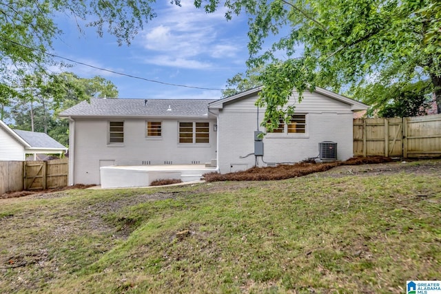 1324 Laurence St, Irondale, AL 35210 - back of property featuring central AC unit, a gate, brick siding, and a patio