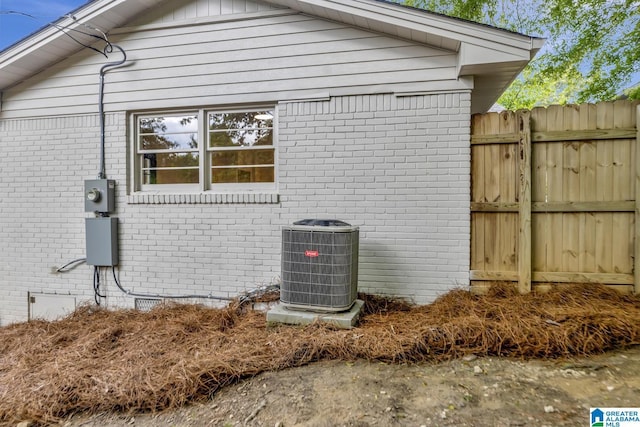 1324 Laurence St, Irondale, AL 35210 - view of side of home with cooling unit, brick siding, and fence