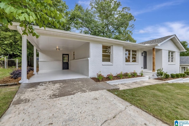 1324 Laurence St, Irondale, AL 35210 - view of front facade with brick siding, driveway, an attached carport, and fence