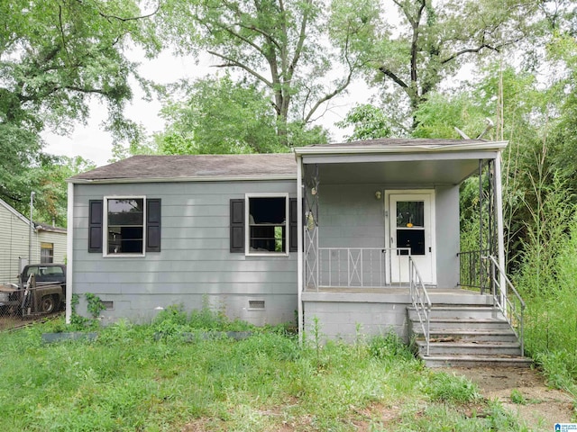 view of front of property featuring crawl space, roof with shingles, and a porch