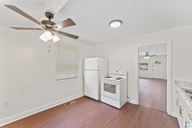 kitchen with white appliances, a ceiling fan, dark wood-style floors, white cabinets, and baseboards