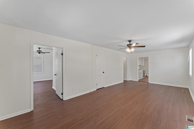 unfurnished living room featuring a ceiling fan, dark wood-type flooring, and baseboards