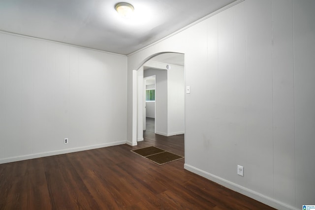 415 Thomas St, Warrior, AL 35180 - empty room featuring arched walkways, baseboards, and dark wood-style floors