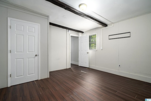 415 Thomas St, Warrior, AL 35180 - unfurnished bedroom featuring beamed ceiling and wood finished floors
