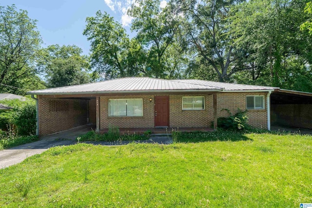 415 Thomas St, Warrior, AL 35180 - view of front facade featuring asphalt driveway, an attached carport, a front yard, and metal roof