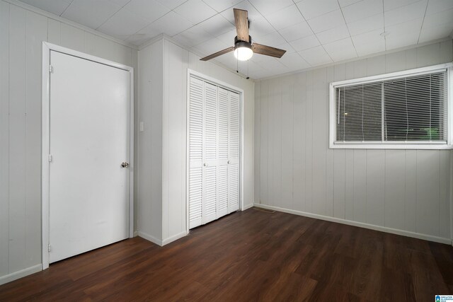 415 Thomas St, Warrior, AL 35180 - unfurnished bedroom featuring dark wood finished floors, a ceiling fan, a closet, baseboards, and crown molding