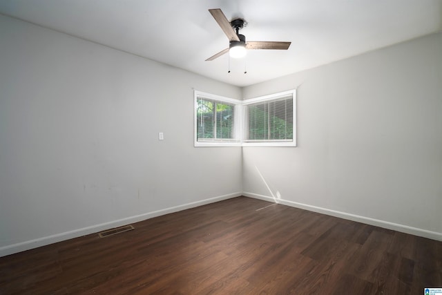 415 Thomas St, Warrior, AL 35180 - empty room with dark wood-style flooring, baseboards, and ceiling fan
