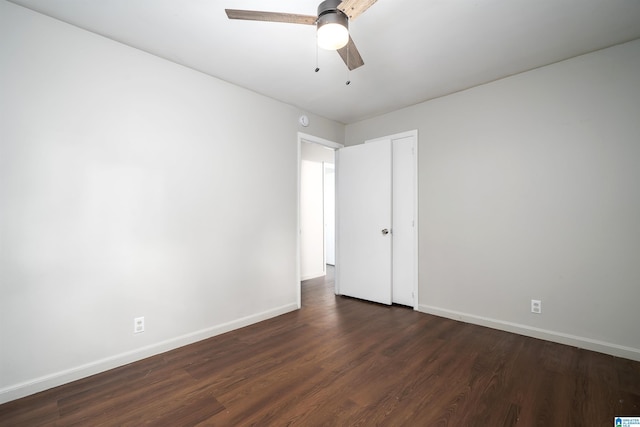415 Thomas St, Warrior, AL 35180 - unfurnished bedroom featuring dark wood-style floors, baseboards, ceiling fan, and a closet