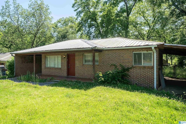 415 Thomas St, Warrior, AL 35180 - view of front facade featuring brick siding, a front yard, and metal roof