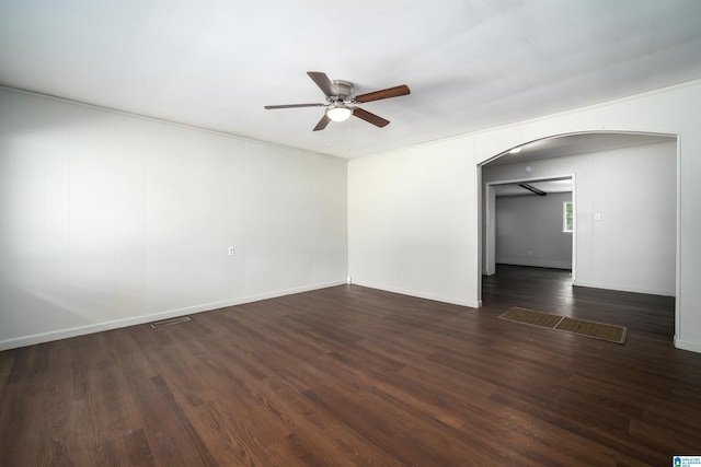 415 Thomas St, Warrior, AL 35180 - empty room with arched walkways, a ceiling fan, dark wood finished floors, and baseboards