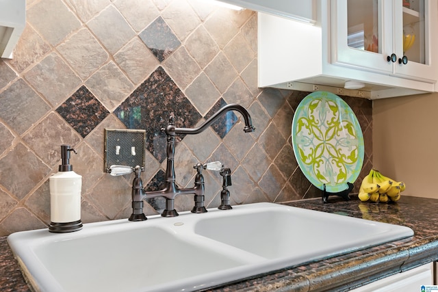 detailed view of a sink and tasteful backsplash