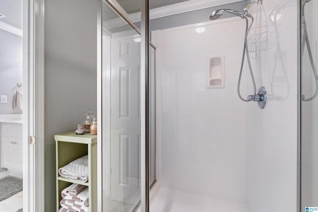 bathroom with a shower stall and ornamental molding
