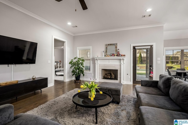 11411 Stella Way, Northport, AL 35475 - living area with wood finished floors, ornamental molding, a ceiling fan, a tiled fireplace, and recessed lighting