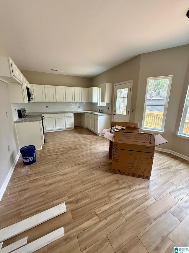 7209 Pamela St, Leeds, AL 35094 - kitchen with electric range oven, a sink, white cabinetry, and light wood finished floors