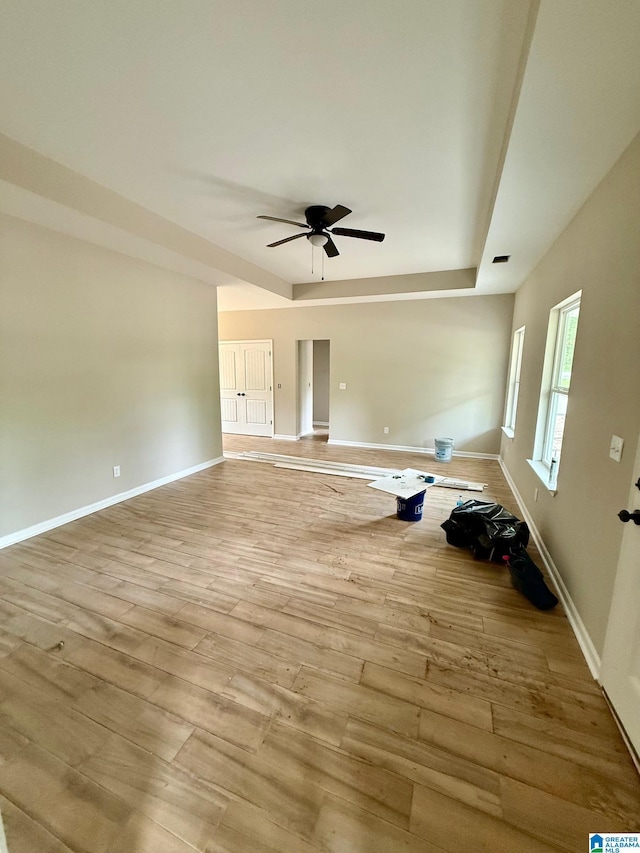 7209 Pamela St, Leeds, AL 35094 - unfurnished living room with a ceiling fan, wood finished floors, baseboards, and a raised ceiling