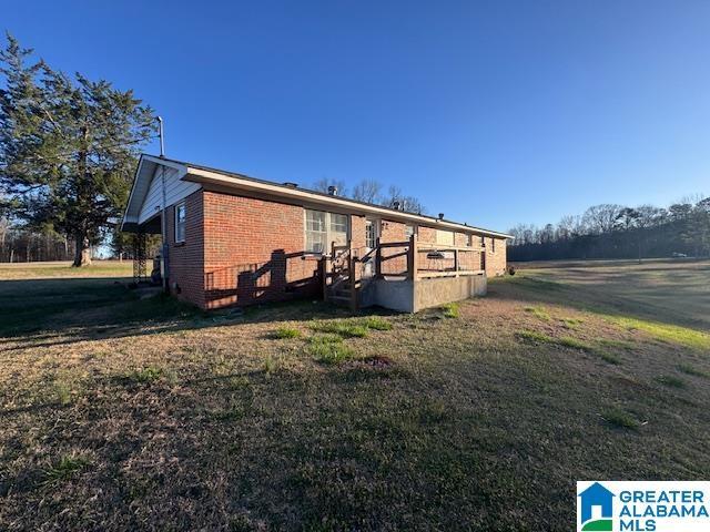 3585 County Road 26, Wadley, AL 36276 - back of house featuring brick siding and a yard