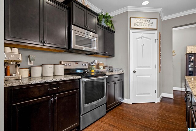 300 Braddock Rd W, Springville, AL 35146 - kitchen with stainless steel appliances, dark wood-style floors, crown molding, light stone countertops, and baseboards