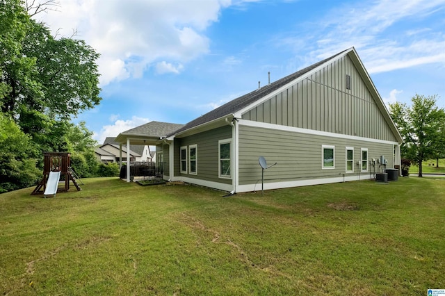 300 Braddock Rd W, Springville, AL 35146 - back of house featuring board and batten siding, a yard, cooling unit, and a shingled roof