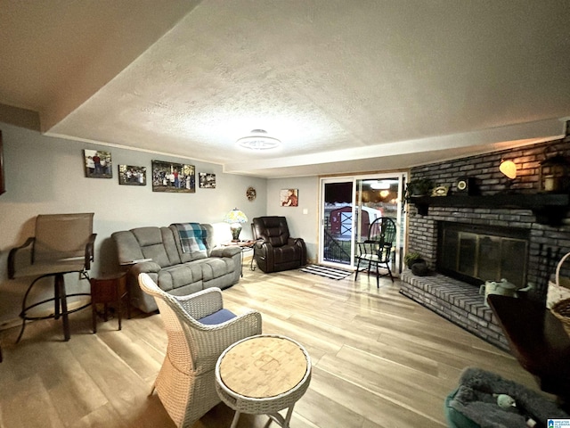 1080 Garmon Rd, Gadsden, AL 35901 - living area with wood finished floors, a brick fireplace, and a textured ceiling