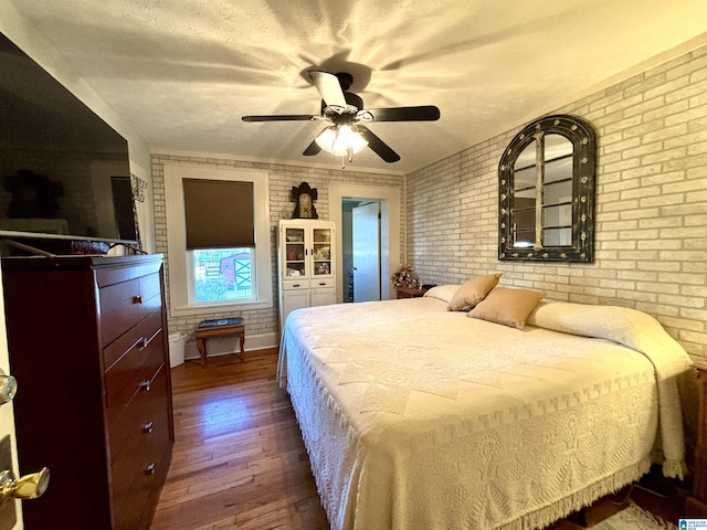 1080 Garmon Rd, Gadsden, AL 35901 - bedroom featuring brick wall, dark wood finished floors, and a ceiling fan
