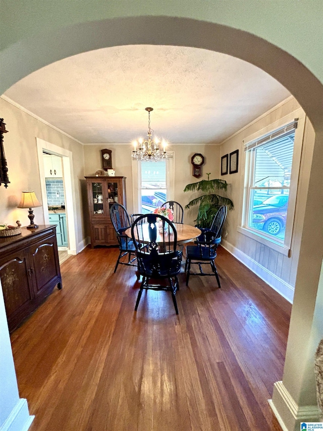 1080 Garmon Rd, Gadsden, AL 35901 - dining space with wood finished floors, a chandelier, arched walkways, ornamental molding, and baseboards