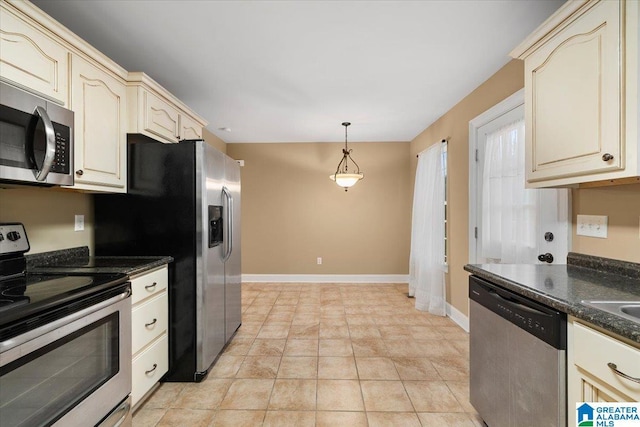 201 Hidden Meadows Dr, Hayden, AL 35079 - kitchen featuring appliances with stainless steel finishes, dark countertops, cream cabinetry, and baseboards