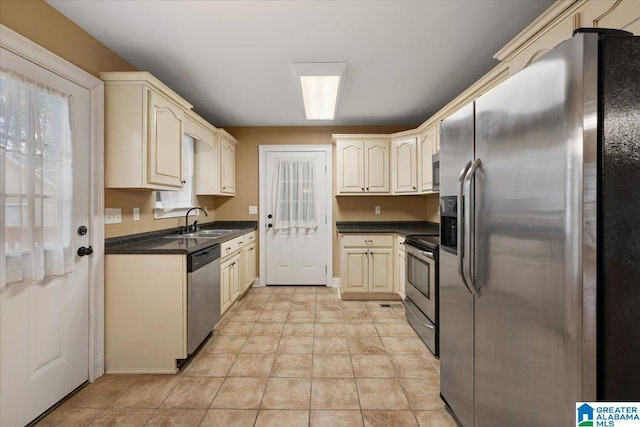 201 Hidden Meadows Dr, Hayden, AL 35079 - kitchen featuring stainless steel appliances, a sink, dark countertops, and cream cabinetry