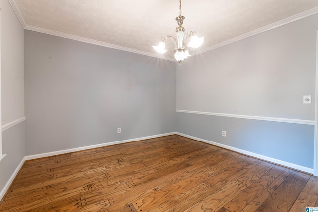 1201 Devonshire Dr NE, Jacksonville, AL 36265 - empty room with a chandelier, wood finished floors, baseboards, and crown molding