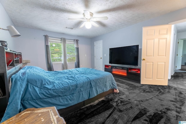 1201 Devonshire Dr NE, Jacksonville, AL 36265 - carpeted bedroom featuring a textured ceiling and ceiling fan