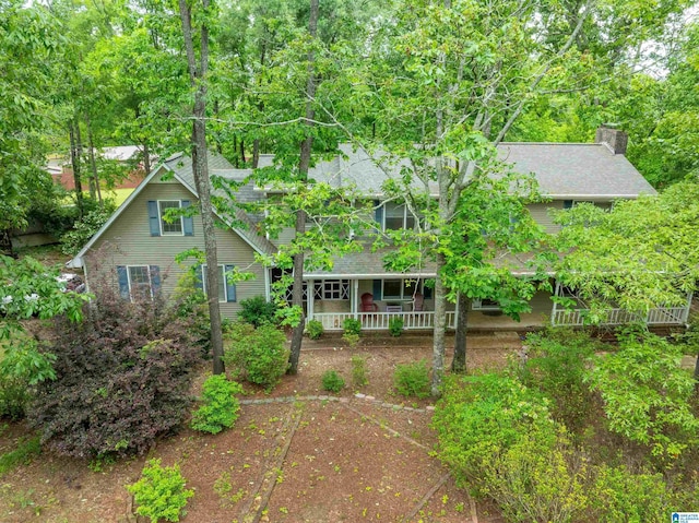 1201 Devonshire Dr NE, Jacksonville, AL 36265 - obstructed view of property with covered porch, a shingled roof, and a chimney