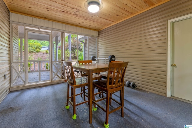 1201 Devonshire Dr NE, Jacksonville, AL 36265 - dining area with carpet floors, wooden walls, and wood ceiling