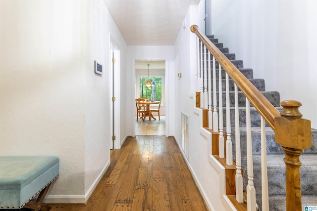 1201 Devonshire Dr NE, Jacksonville, AL 36265 - hall featuring hardwood / wood-style floors, stairs, and baseboards