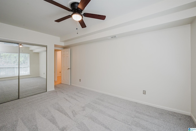 unfurnished bedroom with carpet flooring, baseboards, ceiling fan, and a closet