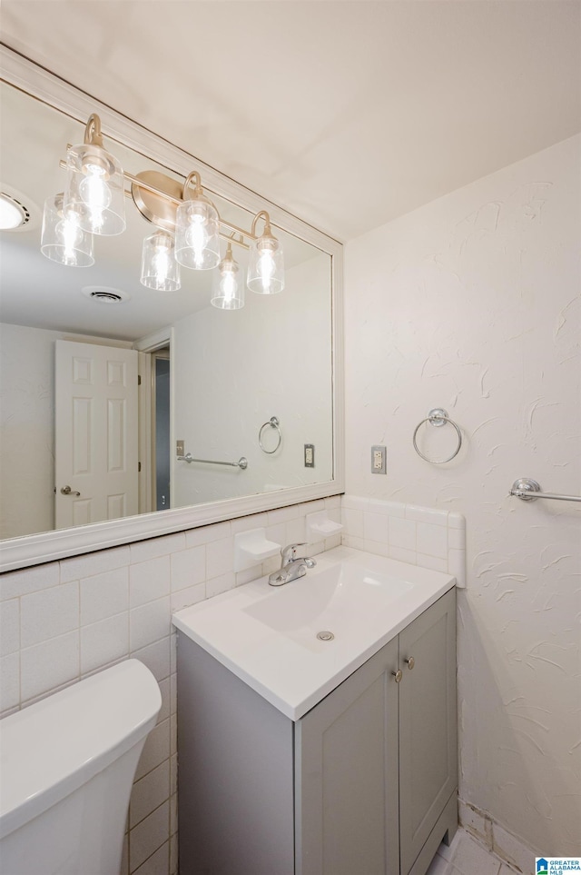 half bathroom with toilet and vanity