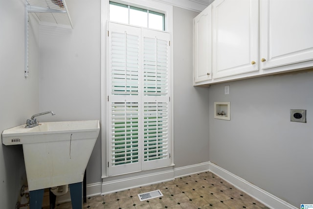 408 Macdonald Lake Rd, Springville, AL 35146 - clothes washing area featuring cabinet space, hookup for an electric dryer, washer hookup, baseboards, and light floors