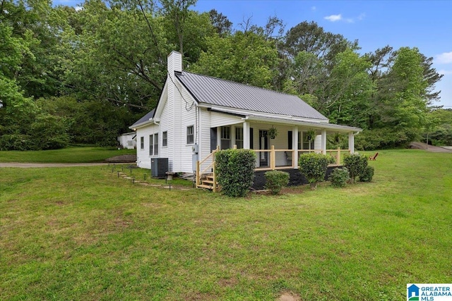 1034 Valley Rd, Oneonta, AL 35121 - view of side of home with covered porch, a lawn, a chimney, and metal roof