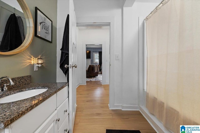 1034 Valley Rd, Oneonta, AL 35121 - bathroom with wood finished floors, vanity, and baseboards