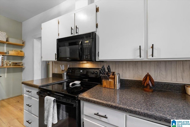 1034 Valley Rd, Oneonta, AL 35121 - kitchen with black appliances, white cabinets, dark countertops, and light wood-type flooring