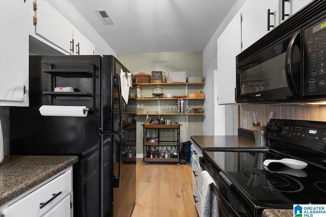 1034 Valley Rd, Oneonta, AL 35121 - kitchen with black appliances, white cabinetry, light wood-style floors, and dark countertops