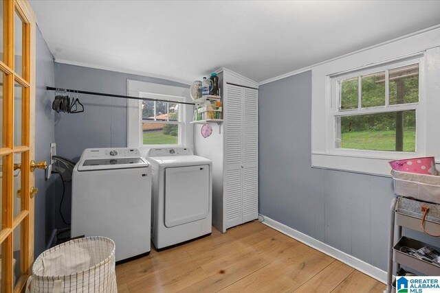 1034 Valley Rd, Oneonta, AL 35121 - clothes washing area featuring washing machine and dryer, light wood-style floors, healthy amount of natural light, crown molding, and baseboards