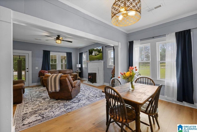 1034 Valley Rd, Oneonta, AL 35121 - dining area featuring ornamental molding, wood finished floors, a brick fireplace, plenty of natural light, and baseboards
