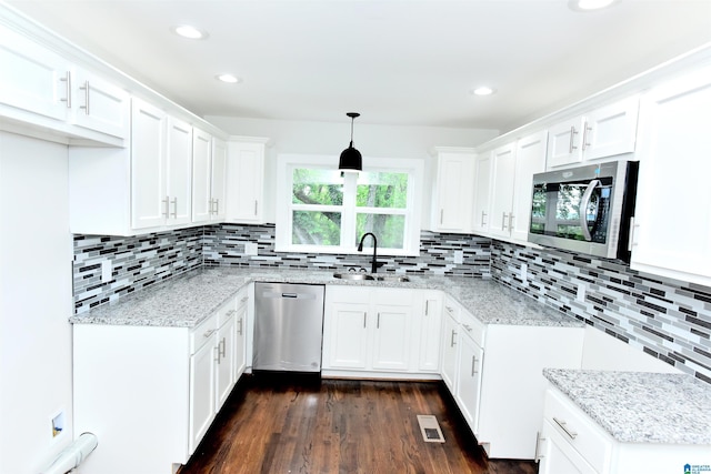 1545 32nd St, Birmingham, AL 35218 - kitchen featuring stainless steel appliances, a sink, light stone counters, dark wood-style floors, and recessed lighting