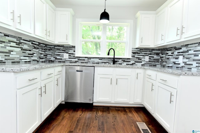 1545 32nd St, Birmingham, AL 35218 - kitchen with stainless steel dishwasher, dark wood-style floors, white cabinets, and backsplash