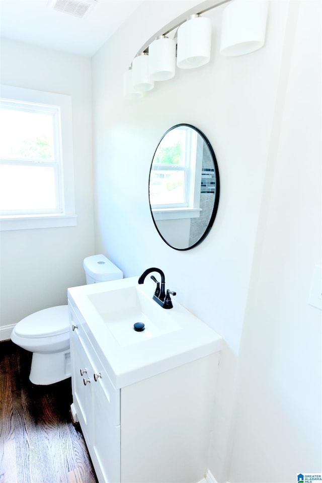 1545 32nd St, Birmingham, AL 35218 - half bath featuring wood finished floors, toilet, and vanity
