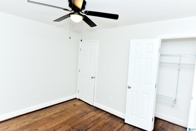 1545 32nd St, Birmingham, AL 35218 - unfurnished bedroom featuring dark wood-type flooring, baseboards, a closet, and a ceiling fan
