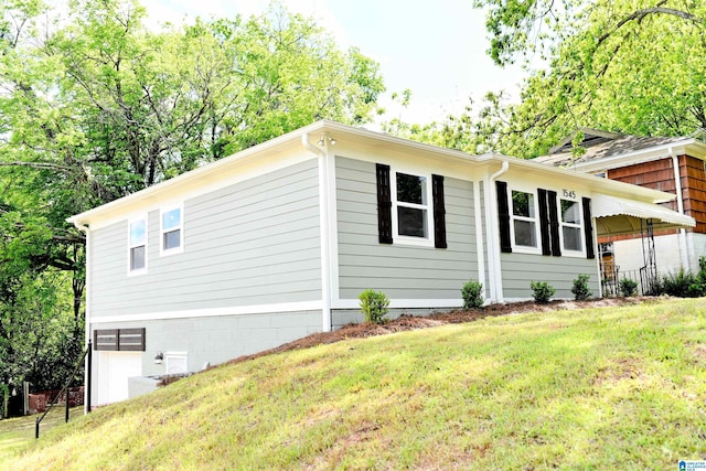 1545 32nd St, Birmingham, AL 35218 - view of side of property with a yard and a garage