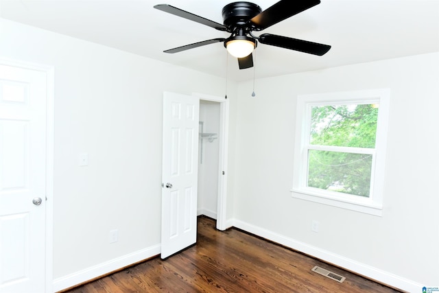 1545 32nd St, Birmingham, AL 35218 - unfurnished bedroom with baseboards, dark wood-style floors, and ceiling fan