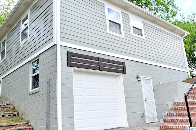1545 32nd St, Birmingham, AL 35218 - view of home's exterior featuring a garage and stairway